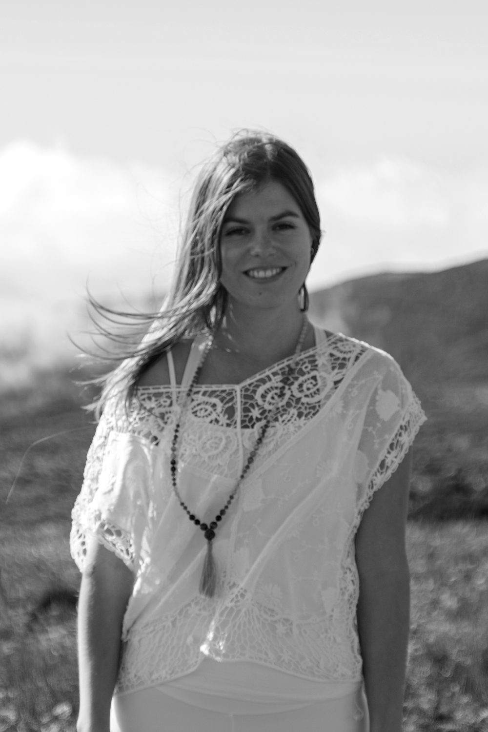 Kelly smiling on a windy hilltop in Madeira